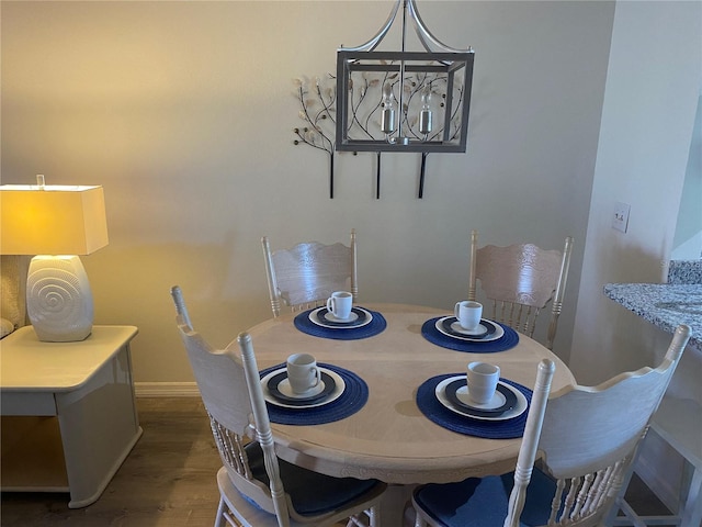 dining space featuring dark wood-type flooring