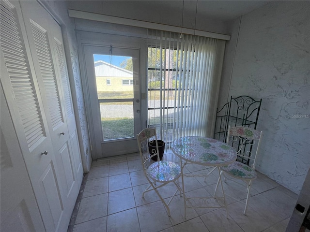 unfurnished dining area featuring light tile patterned floors