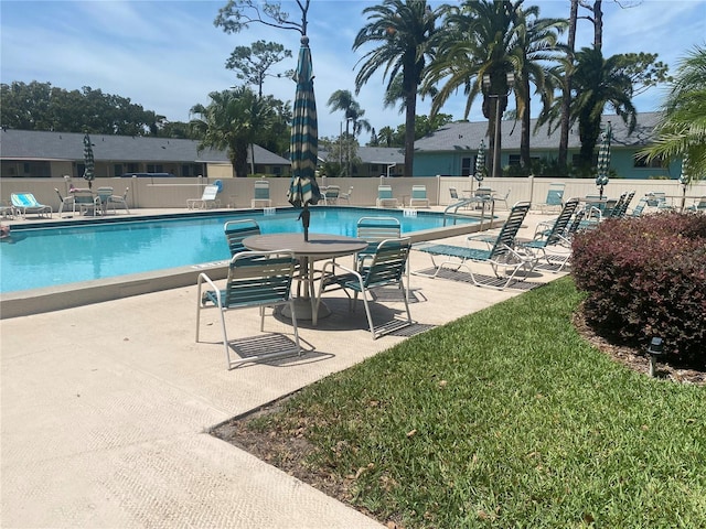 view of swimming pool with a yard and a patio area