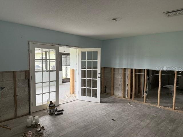 miscellaneous room featuring hardwood / wood-style flooring and french doors