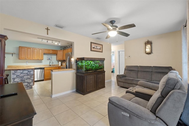 tiled living room with sink and ceiling fan