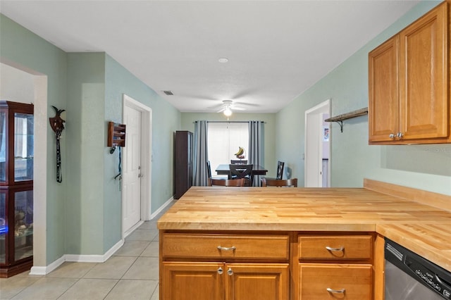 kitchen featuring light tile patterned floors, wooden counters, dishwasher, ceiling fan, and kitchen peninsula