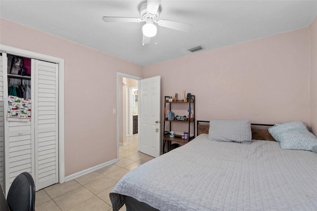 tiled bedroom with a closet and ceiling fan