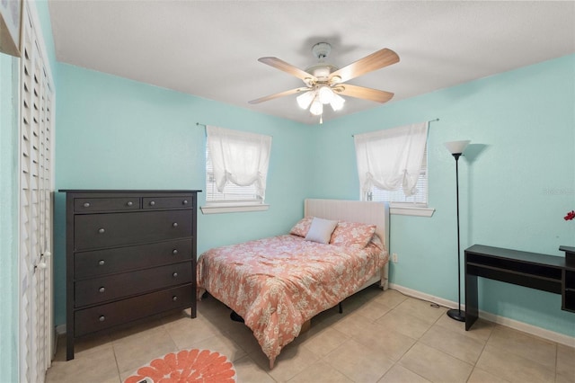 tiled bedroom with ceiling fan