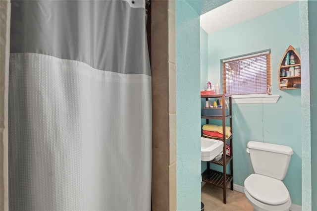 bathroom with a shower with curtain and toilet