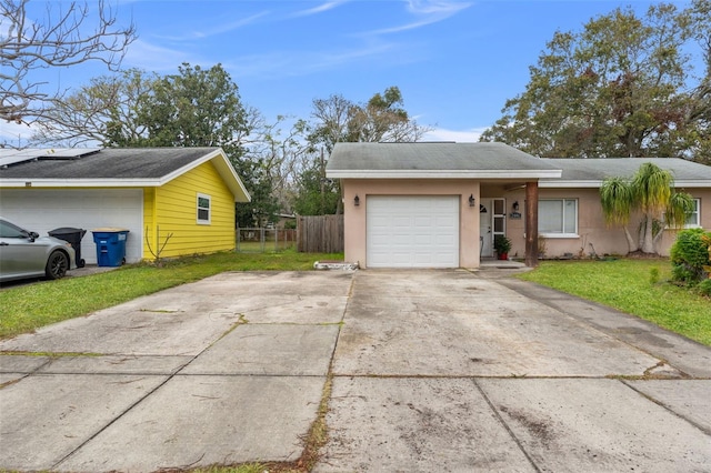 view of side of property featuring a yard and a garage