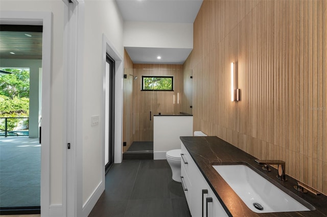 5038 W Dickens Ave, Tampa, FL 33629 - full bathroom featuring a stall shower, toilet, vanity, and baseboards