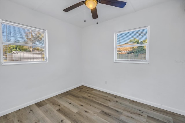 unfurnished room with ceiling fan, light hardwood / wood-style flooring, and a wealth of natural light