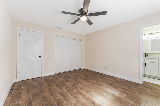 unfurnished bedroom featuring ensuite bath and ceiling fan