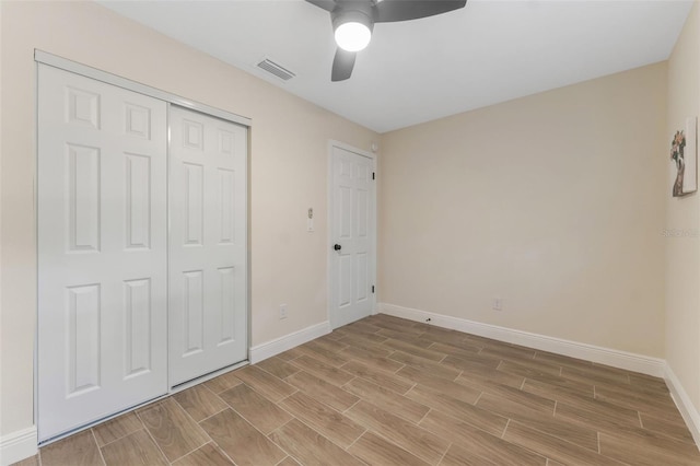 unfurnished bedroom featuring a closet and ceiling fan