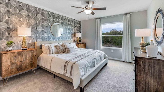 bedroom with ceiling fan and light colored carpet