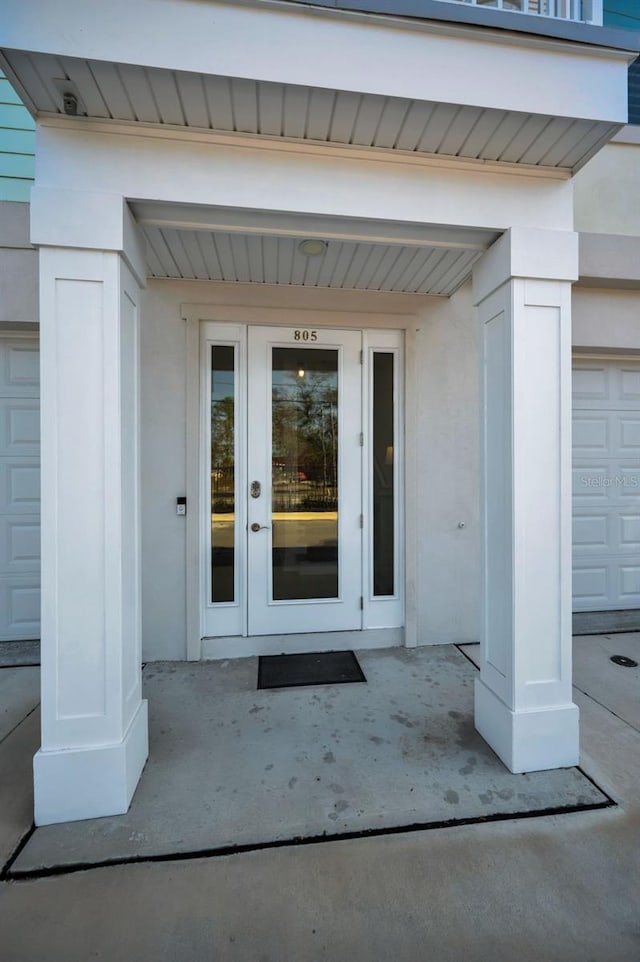 entrance to property with french doors and a garage