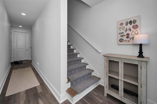 stairway with hardwood / wood-style floors