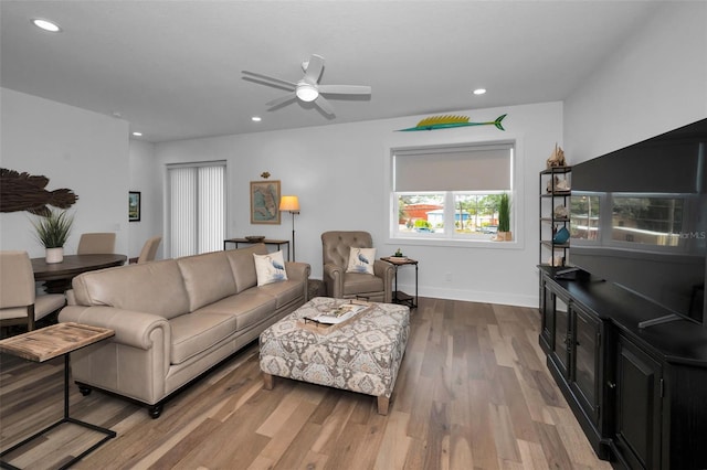 living room featuring light hardwood / wood-style floors and ceiling fan