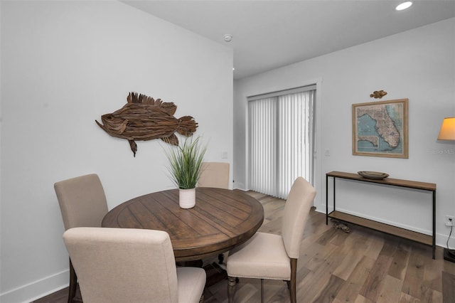 dining space featuring wood-type flooring