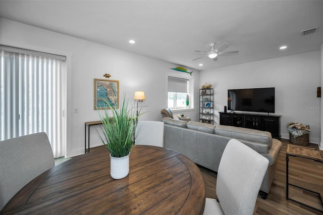 dining area featuring ceiling fan and dark wood-type flooring