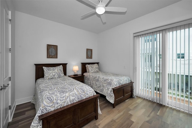 bedroom featuring ceiling fan, access to exterior, and hardwood / wood-style flooring