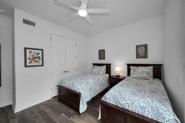 bedroom featuring ceiling fan, a closet, and dark hardwood / wood-style flooring