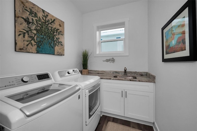 washroom featuring cabinets, separate washer and dryer, dark hardwood / wood-style floors, and sink