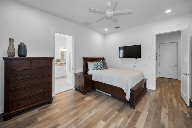 bedroom with ceiling fan, light hardwood / wood-style floors, and ensuite bath