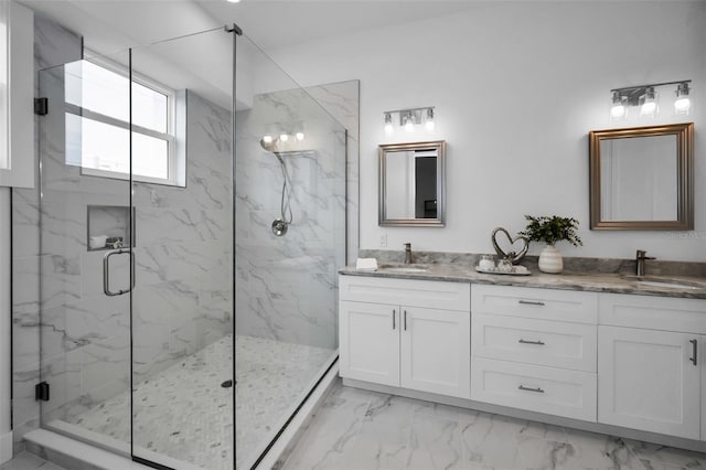 bathroom with vanity and a shower with door