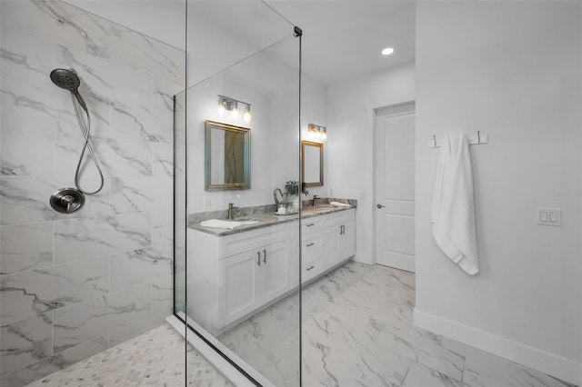 bathroom with vanity and a tile shower