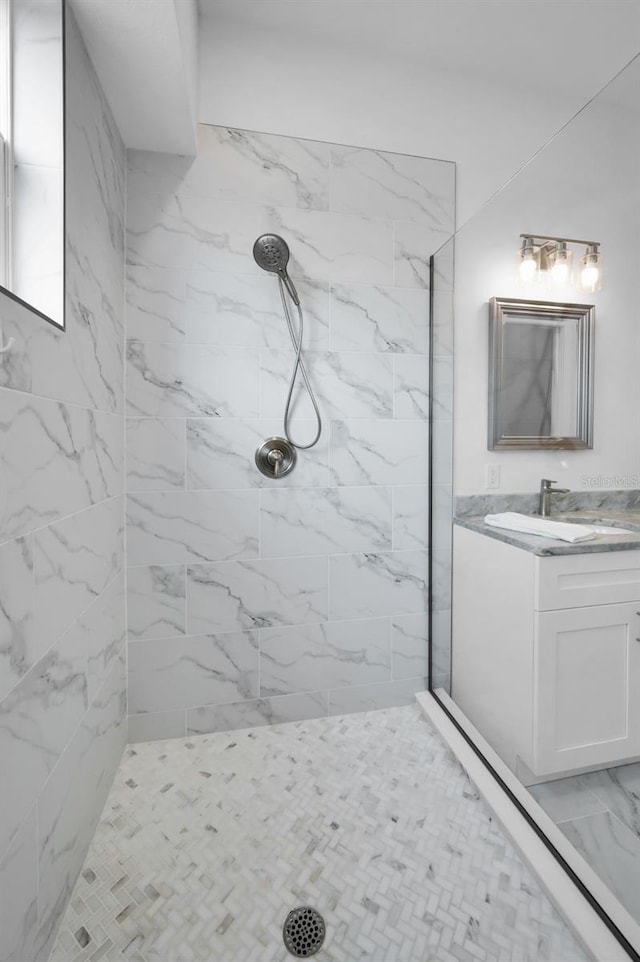 bathroom with vanity and tiled shower