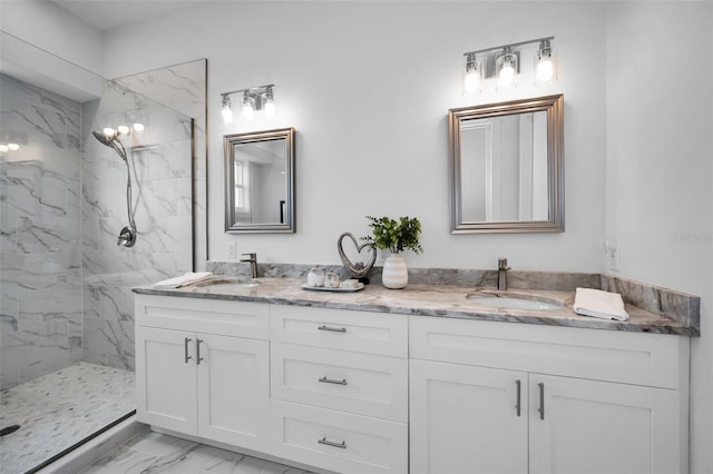 bathroom with vanity and a tile shower