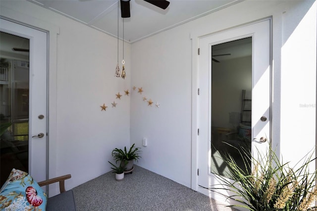 doorway to property featuring ceiling fan