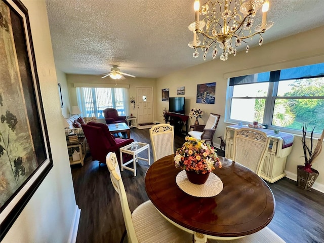 dining space with ceiling fan with notable chandelier, a textured ceiling, and dark hardwood / wood-style flooring