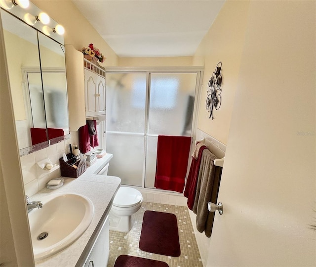 bathroom with toilet, vanity, tile patterned flooring, walk in shower, and decorative backsplash