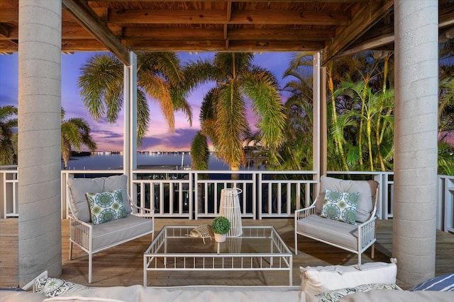 wooden terrace with an outdoor living space