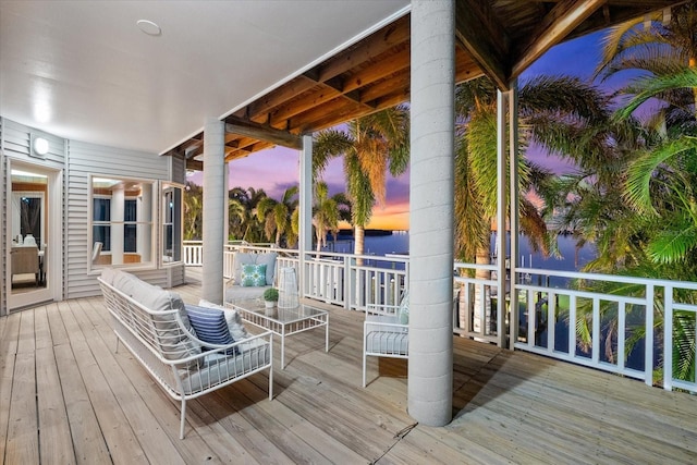 deck at dusk with outdoor lounge area