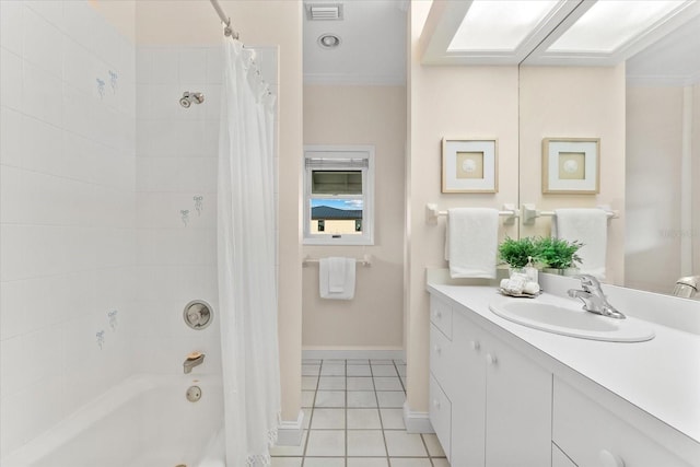 bathroom with tile patterned floors, a skylight, vanity, and shower / bath combo