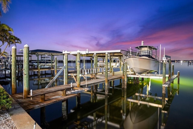 dock area with a water view and boat lift