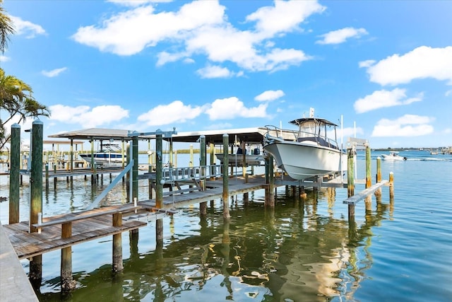 view of dock featuring boat lift and a water view