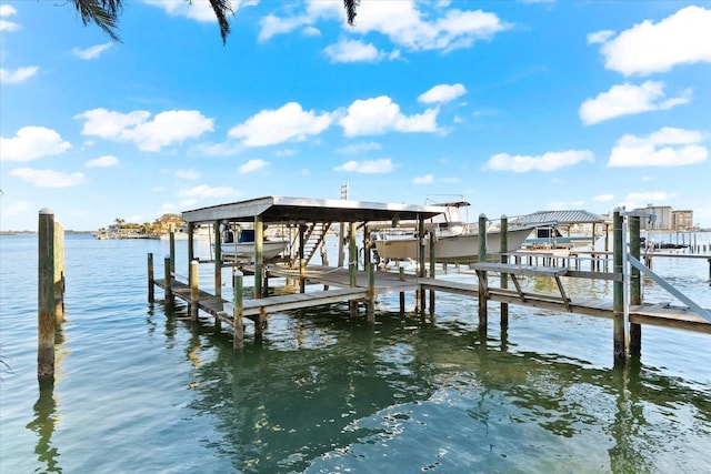 dock area with a water view and boat lift