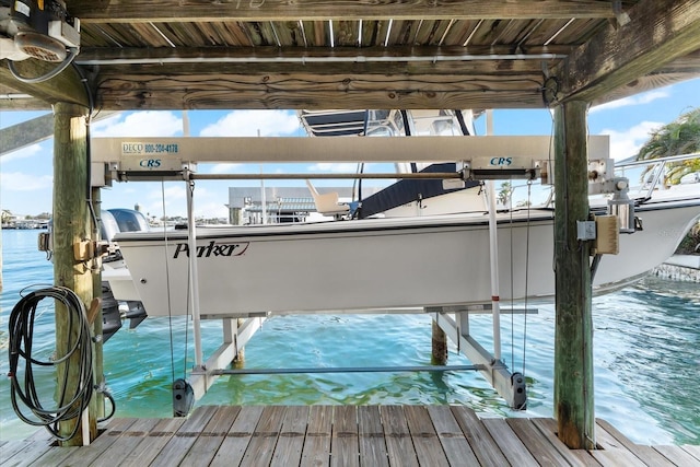 view of dock featuring boat lift and a water view