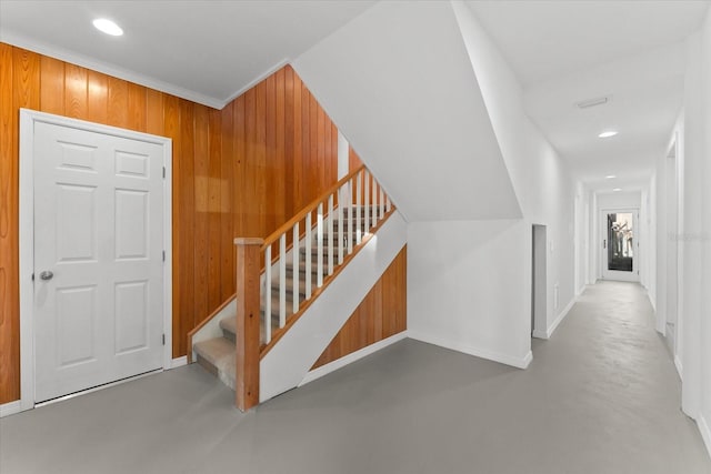 interior space featuring wooden walls and concrete flooring