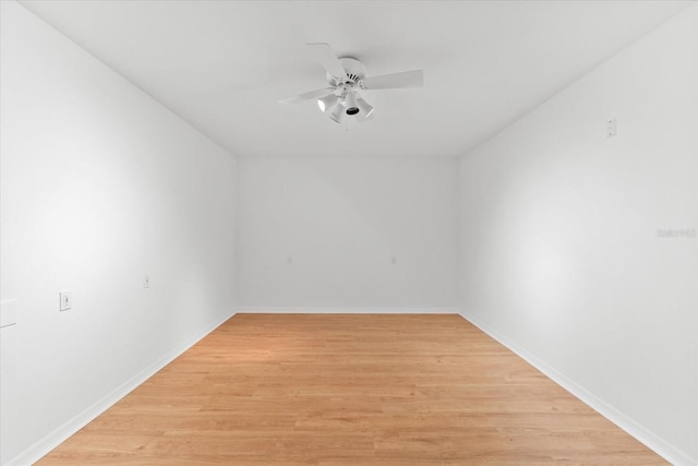 spare room with light wood-style flooring, baseboards, and ceiling fan