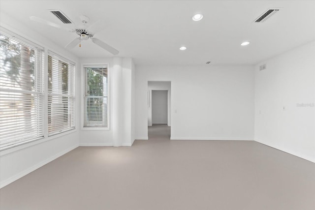 spare room with recessed lighting, visible vents, baseboards, and concrete floors