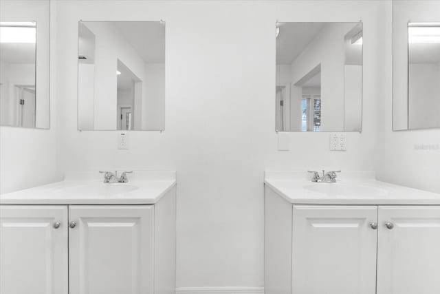 full bath with two vanities and a sink