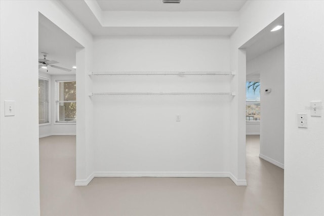 corridor featuring recessed lighting and baseboards