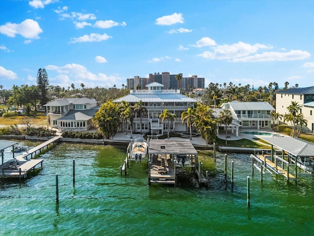 dock area with boat lift, an outdoor pool, and a water view