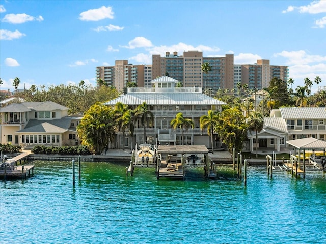 view of pool featuring boat lift, a dock, and a water view