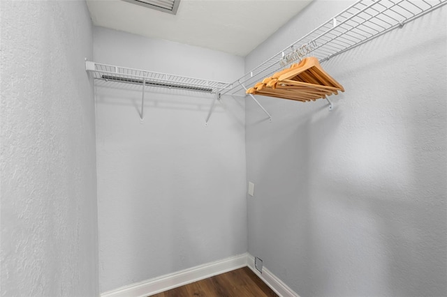 walk in closet featuring dark hardwood / wood-style flooring