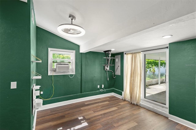 interior space with lofted ceiling, cooling unit, and dark hardwood / wood-style flooring