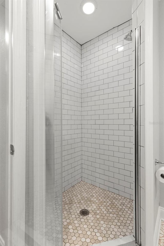 bathroom with a shower with door