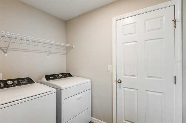 washroom with laundry area and independent washer and dryer