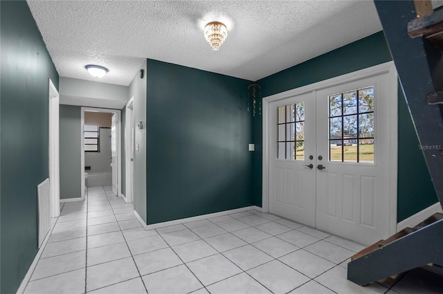 entrance foyer featuring a textured ceiling and light tile patterned flooring